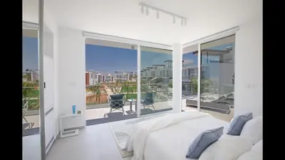 a bedroom with a bed and a large window at Protaras Olivine Villa Ol3 in Protaras