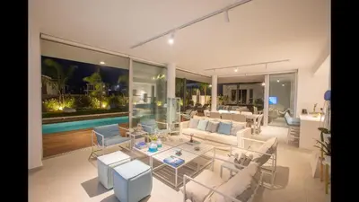 a living room with white furniture and a pool at Protaras Olivine Villa Ol3 in Protaras