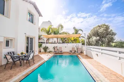 a swimming pool in the backyard of a house at Villa Pepper in Protaras