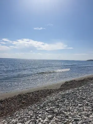 a rocky beach with the ocean in the background at Seafront Beach House in Meneou