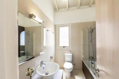 a bathroom with a toilet and a sink and a shower at Protaras Artisan Seafront Villa 1 in Protaras