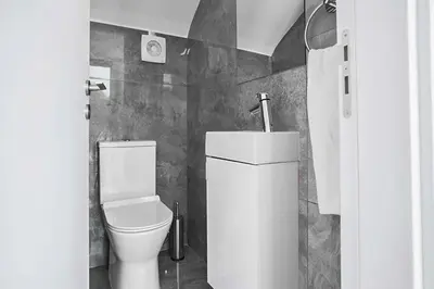 a white bathroom with a toilet and a shower at Villa Macan in Protaras