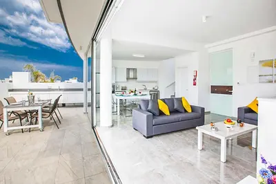 a living room with a couch and a table at Villa Macan in Protaras