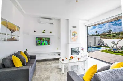 a living room with a couch and a tv at Villa Macan in Protaras