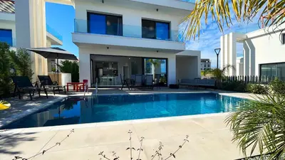 a house with a swimming pool in front of a house at By the Bay Villa,3 BR/pool in Protaras