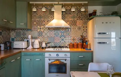 a kitchen with a stove with a fire in the oven at Rozana House in Silikou