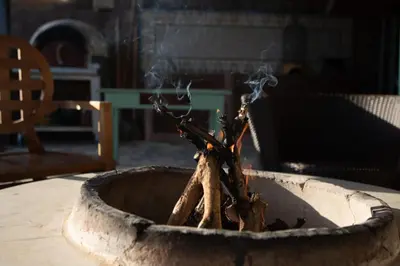 a planter filled with twigs and smoke at Rozana House in Silikou
