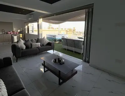 a living room with a couch and a table at Sant Central Deluxe Apartments in Ayia Napa