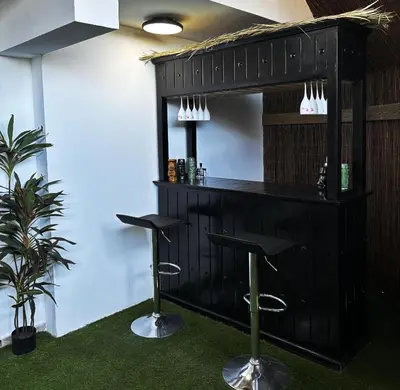 a bar with two stools in a room at Sant Central Deluxe Apartments in Ayia Napa