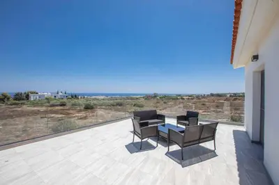 a patio with a table and chairs on a balcony at Villa Demeter GA98 in Paralimni