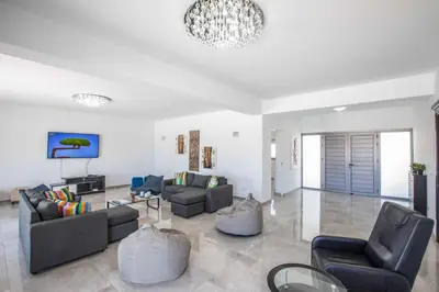 a living room with couches and chairs and a chandelier at Villa Demeter GA98 in Paralimni