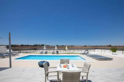 a table and chairs next to a swimming pool at Villa Demeter GA98 in Paralimni
