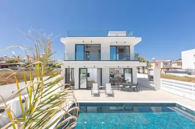 a villa with a swimming pool and a house at Trinity Villa in Paralimni