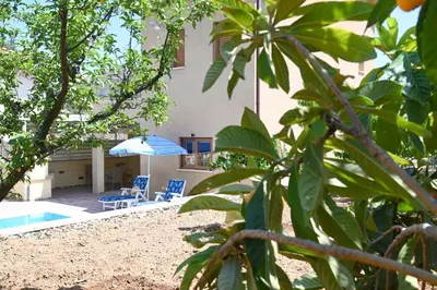 a house with a pool and two chairs and an umbrella at Kakopetria's Holiday House in Kakopetria