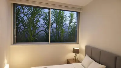 a bedroom with a window with a view of bamboo at Seaview Luxury Villa Fortuna in Ayia Napa