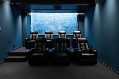 a group of chairs in a room with a window at Seaview Luxury Villa Fortuna in Ayia Napa