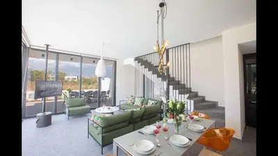 a living room with couches and tables and a staircase at Protaras Elite Pearl Villa Ep17 in Protaras