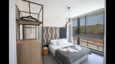 a bedroom with a bed and a large window at Protaras Elite Pearl Villa Ep17 in Protaras
