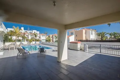 a view of the pool from the balcony of a house at Protaras Holiday Villa Dv1 in Protaras