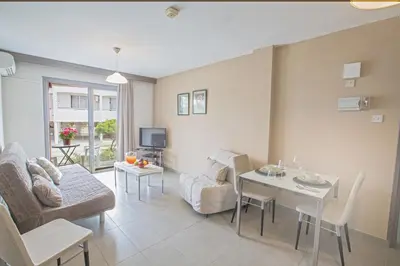 a living room with a couch and a table at Ayia Napa Holiday Apartment So2 in Ayia Napa