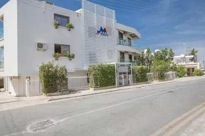 a white building on the side of a street at Ayia Napa Holiday Apartment So7 in Ayia Napa