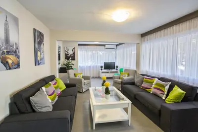 a living room with couches and a table at Ayia Napa Holiday Apartment So3 in Ayia Napa