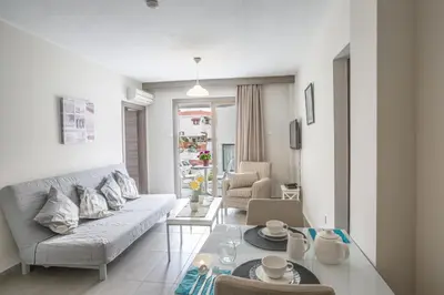 a living room with a couch and a table at Ayia Napa Holiday Apartment So3 in Ayia Napa