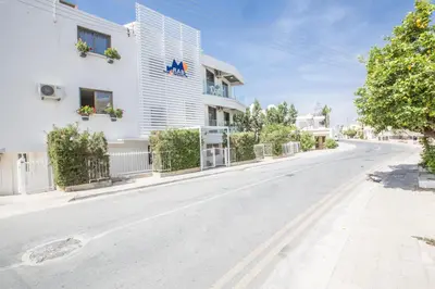 an empty street in front of a white building at Ayia Napa Holiday Apartment So6 in Ayia Napa