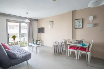a living room with a couch and a table at Ayia Napa Holiday Apartment So6 in Ayia Napa