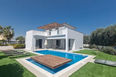 a villa with a swimming pool in front of a house at Ayia Napa Holiday Villa Svd2 in Ayia Napa
