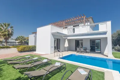 a villa with a swimming pool and lawn at Ayia Napa Holiday Villa Svd2 in Ayia Napa