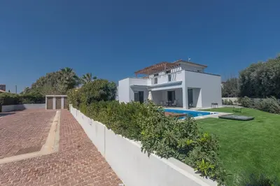a white house with a swimming pool and a yard at Ayia Napa Holiday Villa Svd2 in Ayia Napa
