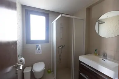 a bathroom with a shower and a toilet and a sink at Ayia Napa Holiday Villa Svd2 in Ayia Napa