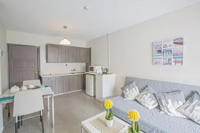a living room with a couch and a kitchen at Ayia Napa Holiday Apartment So8 in Ayia Napa