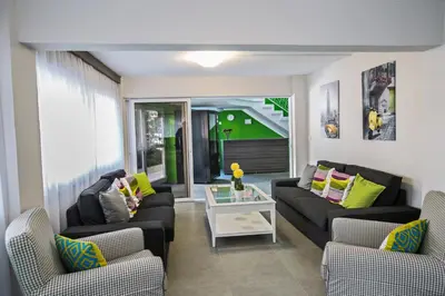 a living room with two couches and a table at Ayia Napa Holiday Apartment So1 in Ayia Napa
