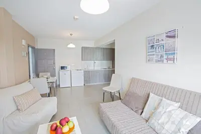 a living room with a couch and a table at Ayia Napa Holiday Apartment So1 in Ayia Napa