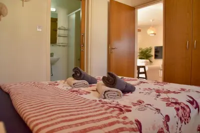 a bedroom with a bed with three pillows on it at Pervolina countryside by the sea in Pervolia