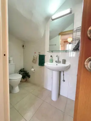 a bathroom with a sink and a toilet and a mirror at Pervolina countryside by the sea in Pervolia