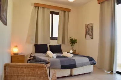 a bedroom with a bed and a window at Pervolina countryside by the sea in Pervolia