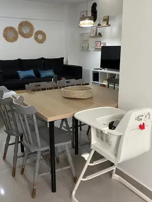 a table and chairs in a living room with a couch at Peaceful 2 bedroom Flat in Engomi