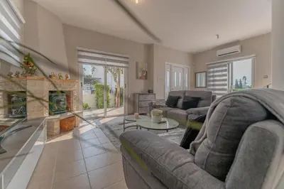 a living room with two couches and a fireplace at Villa Mespila_ Ayia Napa in Ayia Napa