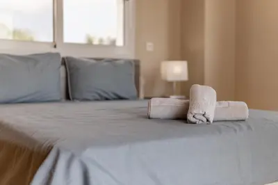 a bedroom with a bed with towels on it at Villa Mespila_ Ayia Napa in Ayia Napa