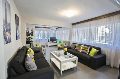 a living room with two couches and a table at Ayia Napa Holiday Apartment Ss1 in Ayia Napa