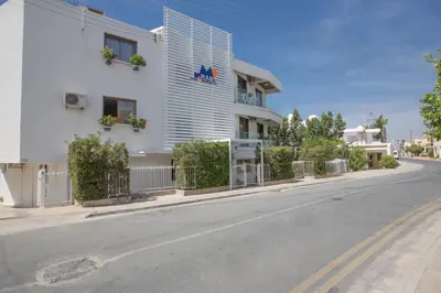 a white building on the side of a street at Ayia Napa Holiday Apartment Ss1 in Ayia Napa