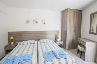 a bedroom with a bed with blue towels on it at Ayia Napa Holiday Apartment Ss1 in Ayia Napa