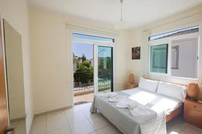 a bedroom with a bed and a large window at Protaras Holiday Villa Dv27 in Protaras