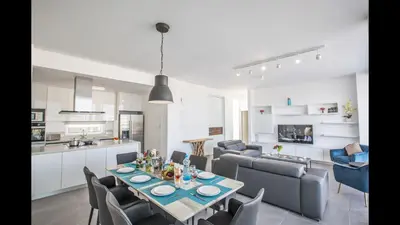 a kitchen and living room with a table and chairs at Protaras Olivine Villa Ol5 in Protaras