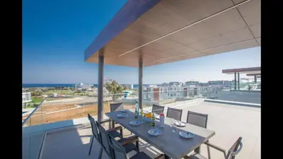 a dining table on the roof of a house at Protaras Olivine Villa Ol5 in Protaras