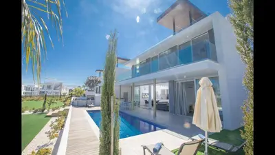 a villa with a swimming pool and a house at Protaras Olivine Villa Ol5 in Protaras