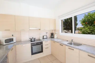 a kitchen with a sink and a microwave at Protaras Delfini Villa Dv8 in Protaras